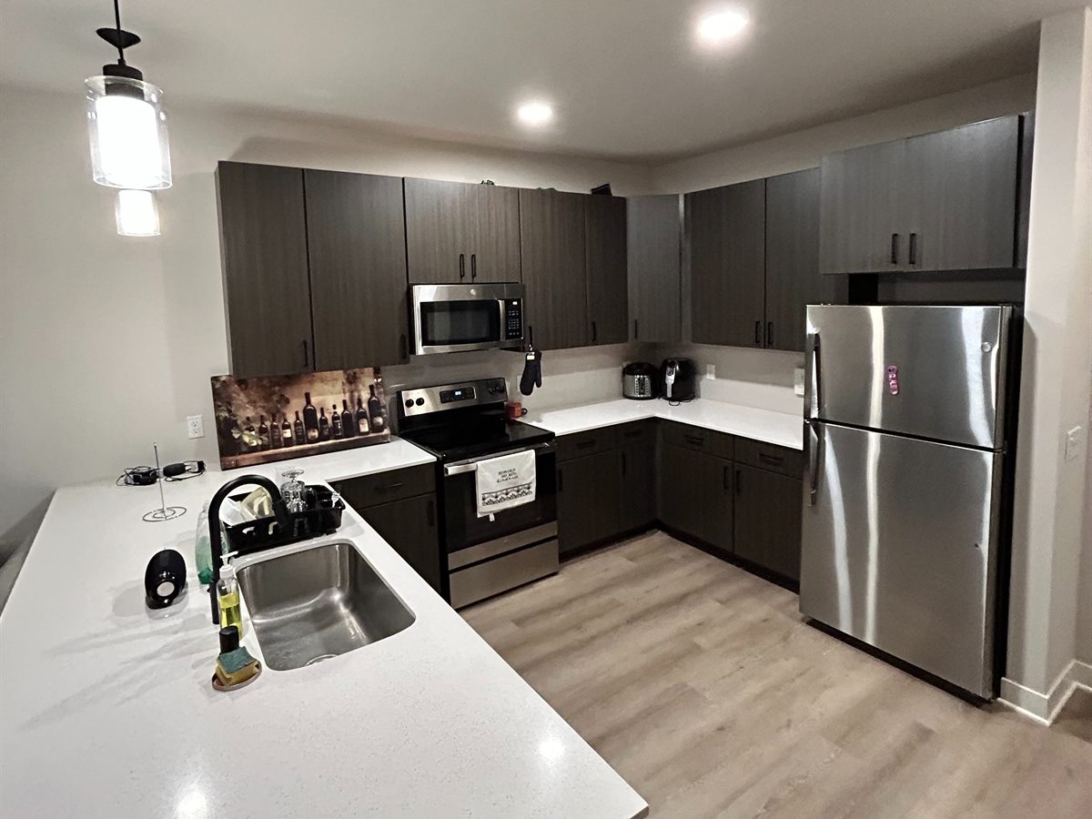 Rental kitchen with cleared counters and clean appliances, ready for the next guest
